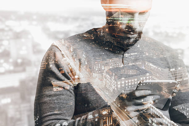 istock Double exposure of city and man using smart tablet 517891658