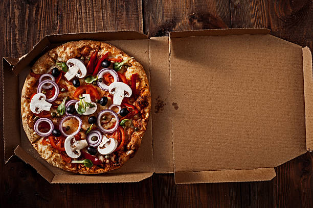 istock pizza in the in delivery box on the wood 517892108