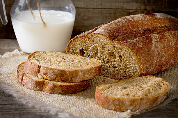 istock Fresh bread slices and milk in a rustic style 517892350