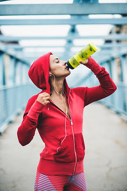 istock Woman drinking water during workout 517893520
