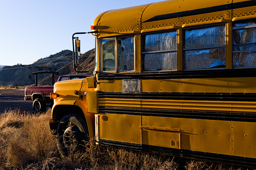 Old Weathered Yellow School Bus - Yellow bus in field left to weather in the sun.