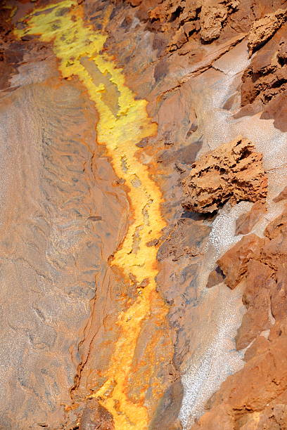 Dallol mountain rising 50-60 ms.over the salt flats. Danakil-Ethiopia. 0309 Dallol mount rising over the surrounding salt flats of Lake Karum or Assale. Colored deposits of sylvite -KCL- carnallite -KMGCL3.6(H2O)- and kainite -KMG(SO4)CL.3H20-. Danakil-Afar region-Ethiopia. dallol ethiopia stock pictures, royalty-free photos & images