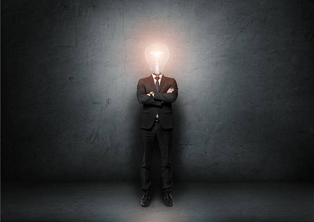 istock Businessman with light bulb instead of head on concrete room 517896762