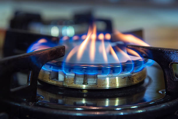 Gas stove burner. Blue flames on gas stove burner. cooktop stock pictures, royalty-free photos & images