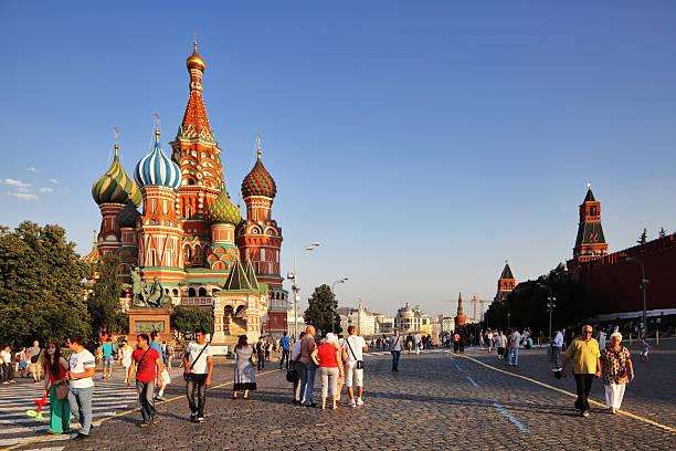 People walking about in Red Square at sunset stock photo