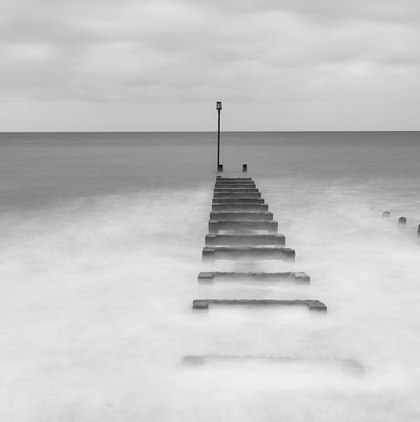 istock Black and white long exposure landscape image of sea 517899300