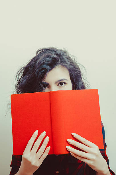 istock Young woman student with red book 517900098