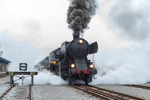 Old steam train, lots of black and gray steam Old steam train leaving the railway station in Nova Gorica, Slovenia, Europe. Lots of black and gray steam hiding the locomotive, full frame, XXXL. nova gorica stock pictures, royalty-free photos & images