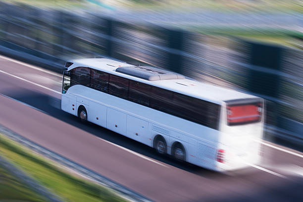 istock White Bus Running on a Fast Lane, Motion Blur 517901129