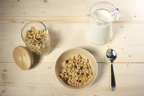istock Delicious and healthy cereal in bowl with milk on table 517901194