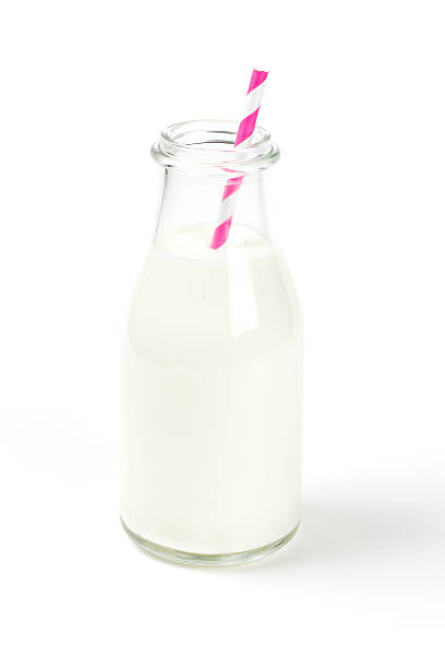 istock bottle of milk with striped straw 517902118