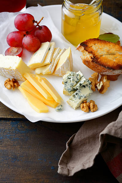 istock Cheese plate served with grapes, honey, bread and walnuts 517902598