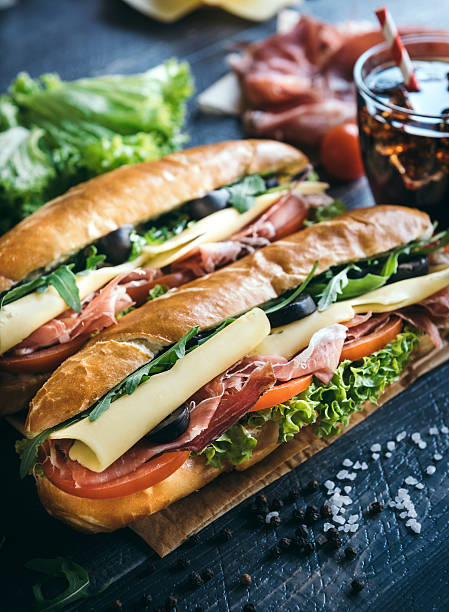 Submarine sandwiches served Submarine sandwiches served on the table,selective focus baguette stock pictures, royalty-free photos & images