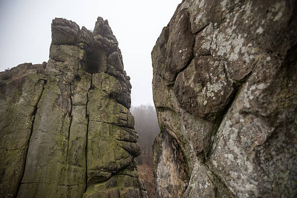 istock externsteine germany in winter fog 517903124