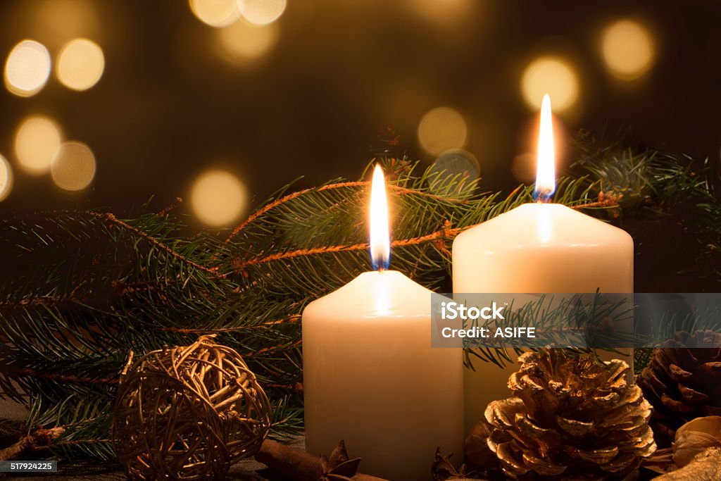 Christmas candles and lights Christmas candles and ornaments over dark background with lights Candle Stock Photo