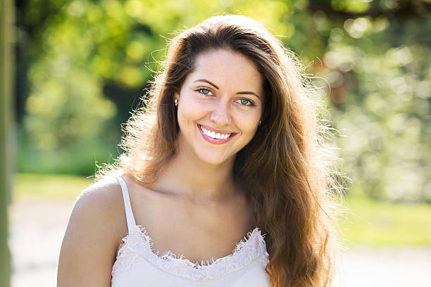 istock Smiling girl in summer park 517924433