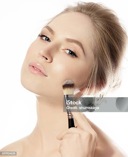 Portrait Of Young Woman With Makeup Foundation Brush Stock Photo - Download Image Now