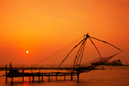 Chinese fishing net at sunset in Kochi, India.