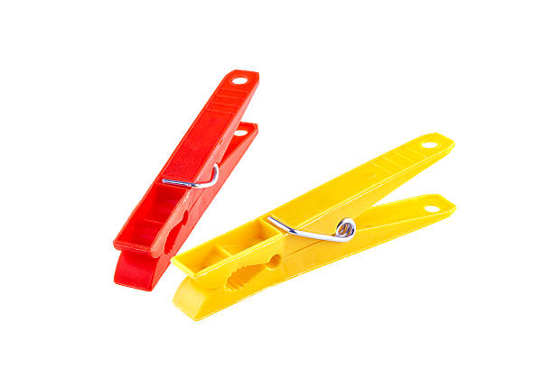 istock Two color clothes-pegs over white 517925074