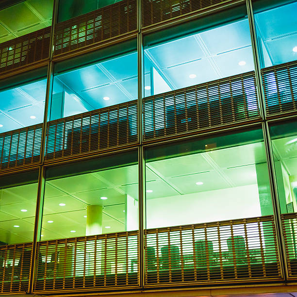 istock Windows of modern office building at night 517926675
