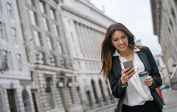 Business woman texting on her phone