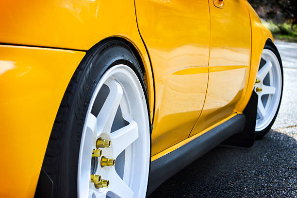 istock Yellow Four Door Car with White Rims 517927653