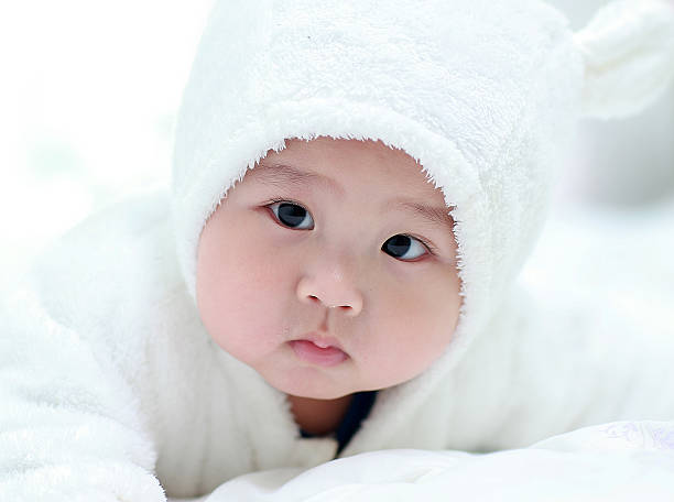 cute indian baby boy lying on the floor with lovely smile in close up