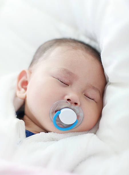 istock Asia baby is playing on the bed 517933630