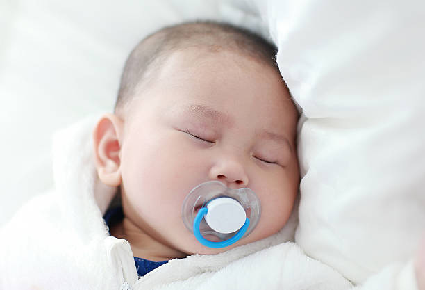 istock Asia baby is playing on the bed 517933660