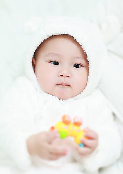 istock Asia baby is playing on the bed 517933872