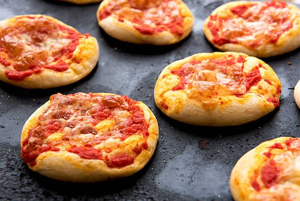 istock Fresh Baked Cheesy Pizza Buns Cooling on Pan 517938576