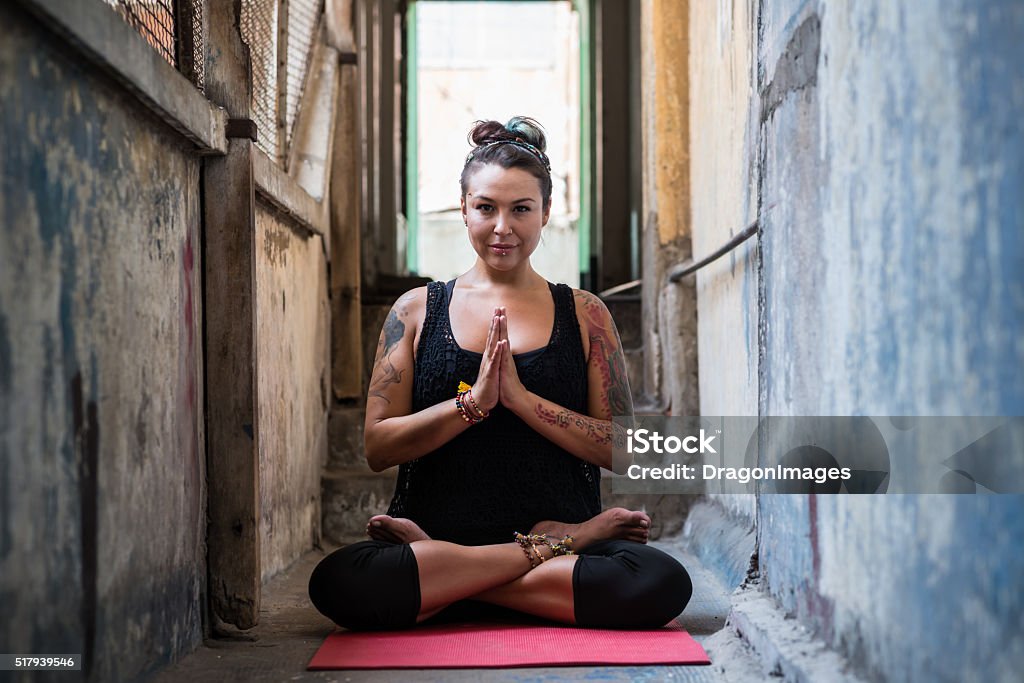 Enjoying yoga Pretty woman enjoying yoga in dilapidating building Adult Stock Photo
