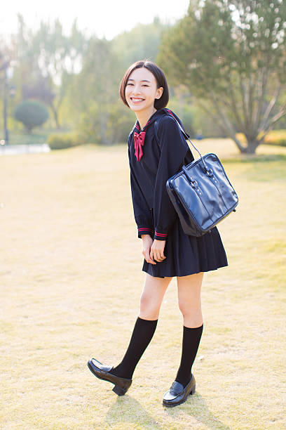 female student in the park beautiful chinese female student, carrying a shoulder bag in the park asian women in stockings stock pictures, royalty-free photos & images