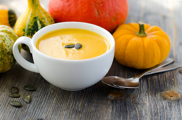 istock Pumpkin soup in a bowl with seeds 517953393