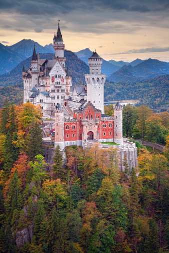 Hohenschwangau, Germany - October 7, 2014: view of Neuschwanstein Castle on october 7th near Hohenschwangau, Germany during autumn afternoon surrounded by fall colours.