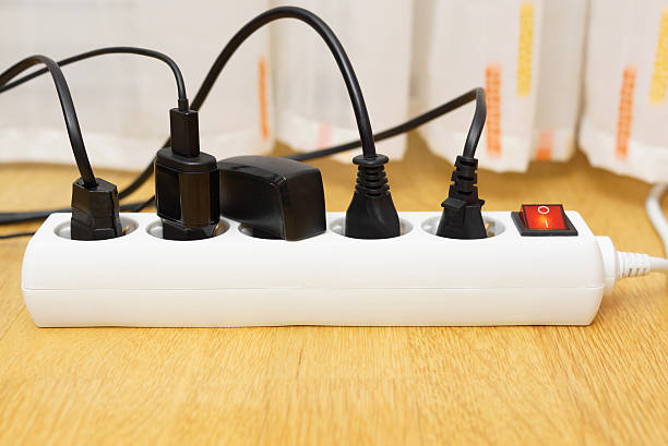 istock many electrical appliances pluged in surge protector. Power consuption concept 517958855