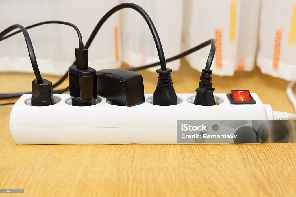 Many Electrical Appliances Pluged In Surge Protector Power