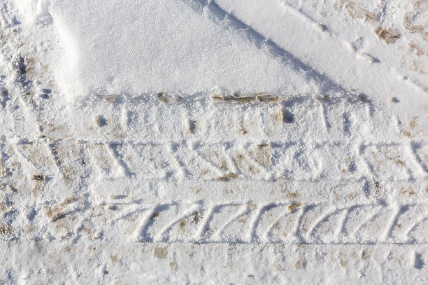 istock Car tire imprint in snow 517960065