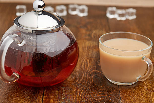 istock Set glass teapot and cup of tea with milk 517961914