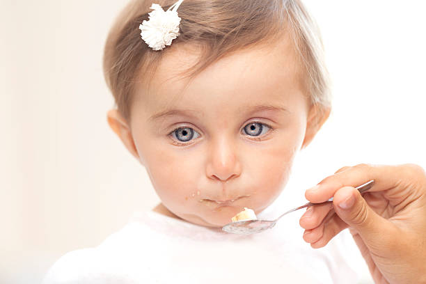 istock Baby girl eating 517962328