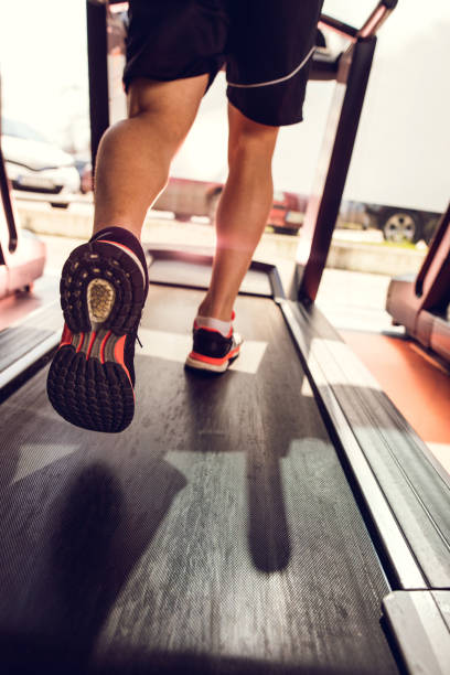 istock Unrecognizable man running on treadmill in a gym. 517963130