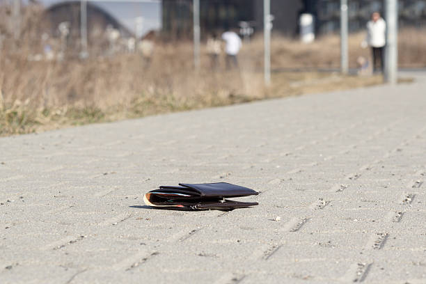 istock Lost brown leather wallet laying on sidewalk 517970946