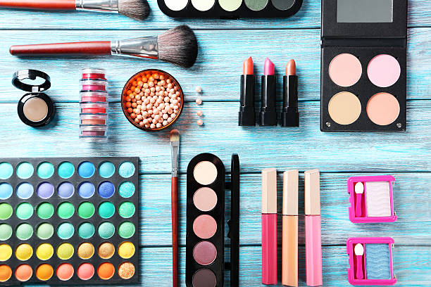 istock Makeup brush and cosmetics on blue wooden table 517971984