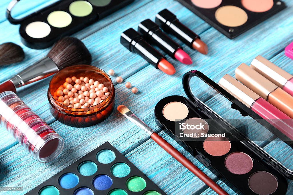 Makeup brush and cosmetics on blue wooden table Artist's Palette Stock Photo