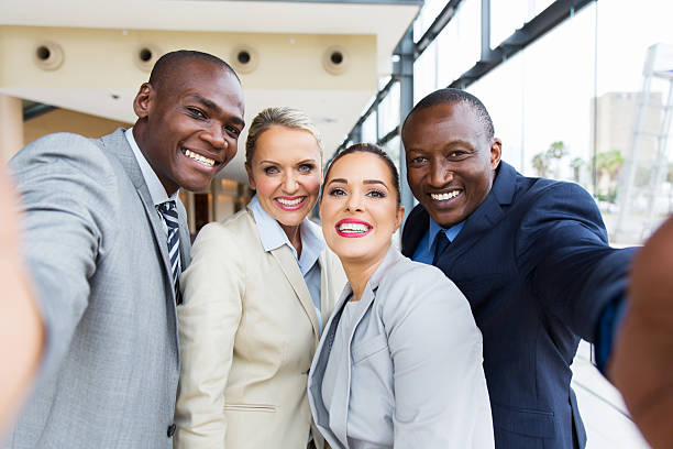 istock multiracial business team taking selfie together 517972414