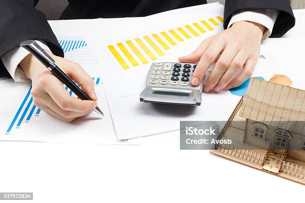 Businessman Signs Contract Behind Home Architectural Model Stock Photo - Download Image Now