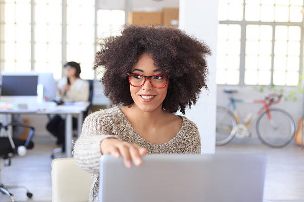 istock Smiling young woman at the office 517974616
