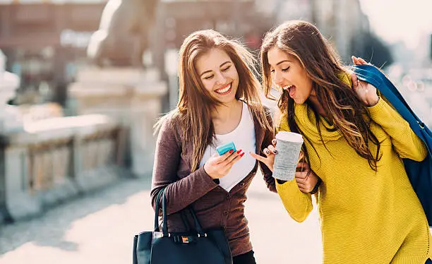 Photo of Friends Texting Outside