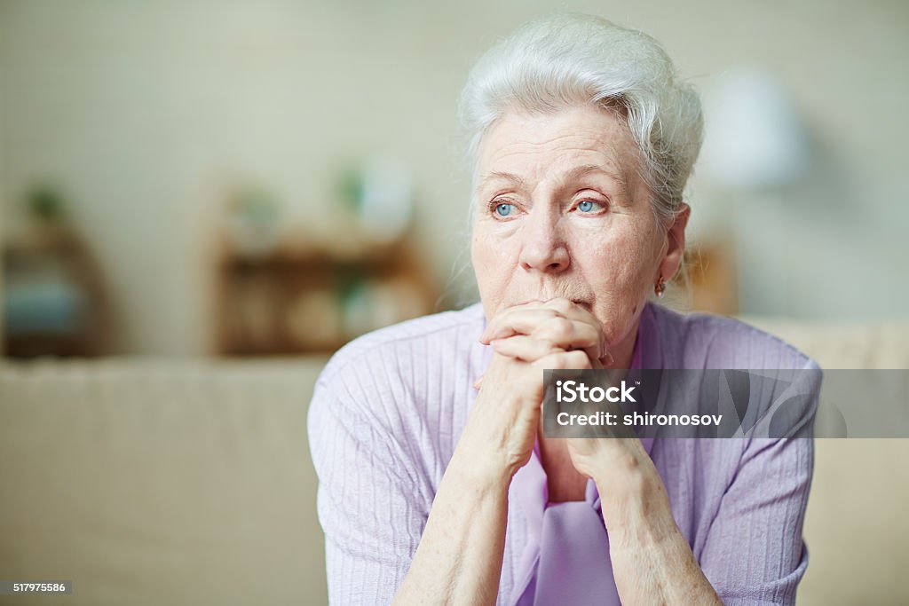 Elderly woman Elderly woman keeping hands by her lips Senior Adult Stock Photo