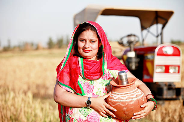 istock Cheerful Farmer women carrying water pot 517988626